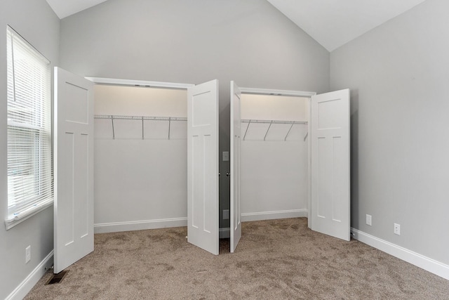 201 Hayes St, Smithville, TN 37166 - unfurnished bedroom featuring high vaulted ceiling, carpet flooring, multiple closets, and baseboards