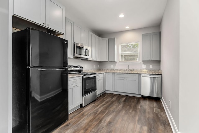 201 Hayes St, Smithville, TN 37166 - kitchen featuring stainless steel appliances, a sink, light stone countertops, dark wood-style flooring, and recessed lighting