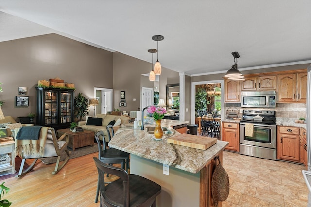 102 Lorelle Cir, Portland, TN 37148 - kitchen featuring appliances with stainless steel finishes, a sink, open floor plan, a breakfast bar area, and ornamental molding