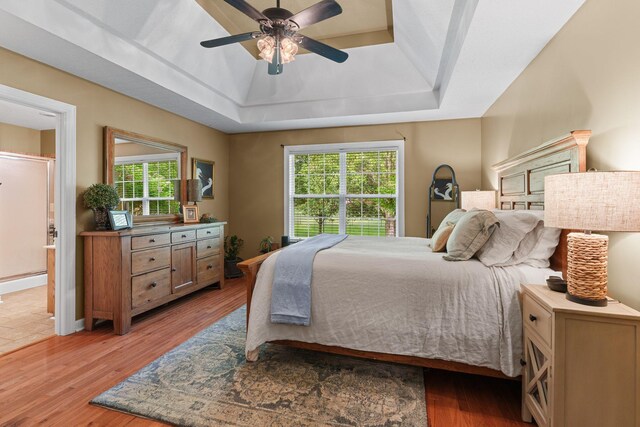 102 Lorelle Cir, Portland, TN 37148 - bedroom featuring a raised ceiling, a baseboard heating unit, multiple windows, and wood finished floors