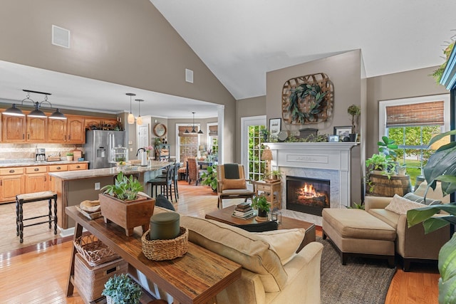 102 Lorelle Cir, Portland, TN 37148 - living area featuring light wood-type flooring, a high end fireplace, and high vaulted ceiling