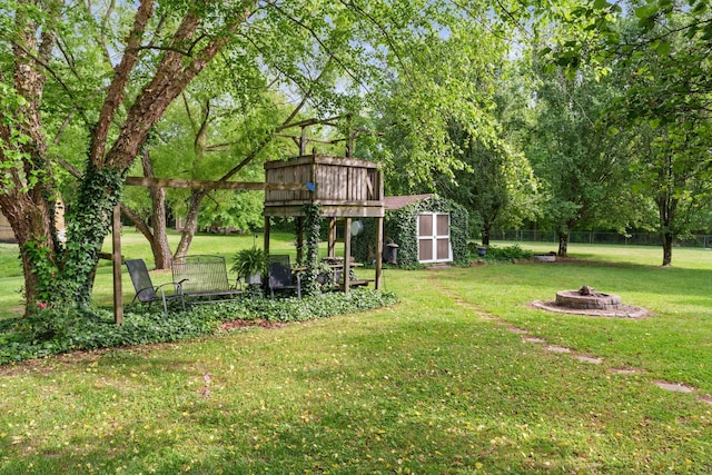 102 Lorelle Cir, Portland, TN 37148 - view of grassy yard featuring a fire pit, a shed, and an outdoor structure