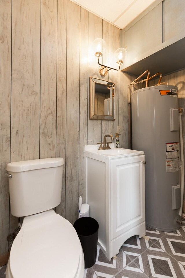 1006 Kirkwood Ave, Murfreesboro, TN 37130 - bathroom with electric water heater, toilet, vanity, and wood walls