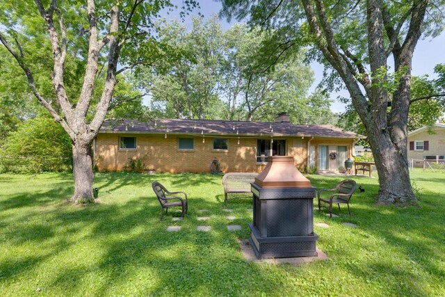 1006 Kirkwood Ave, Murfreesboro, TN 37130 - rear view of property with a yard, a chimney, and brick siding
