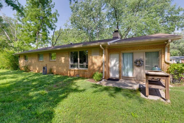 1006 Kirkwood Ave, Murfreesboro, TN 37130 - back of house featuring a chimney, a yard, brick siding, and a patio area