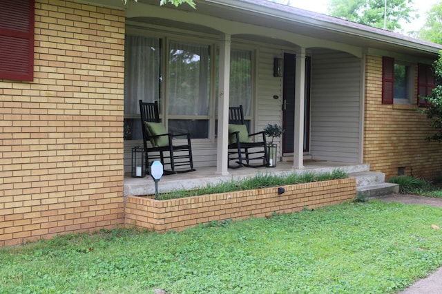 1006 Kirkwood Ave, Murfreesboro, TN 37130 - doorway to property with brick siding, covered porch, and a yard