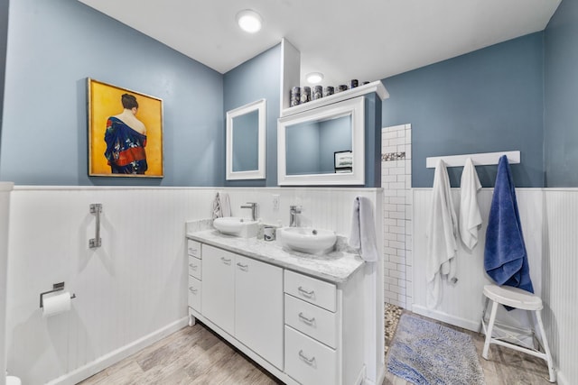 1205 Parker Dr, Pulaski, TN 38478 - full bathroom with a wainscoted wall, wood finished floors, a walk in shower, and double vanity