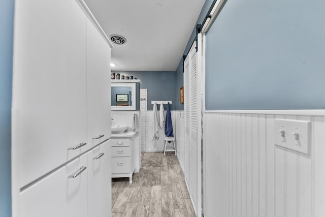 1205 Parker Dr, Pulaski, TN 38478 - bathroom featuring wainscoting and vanity