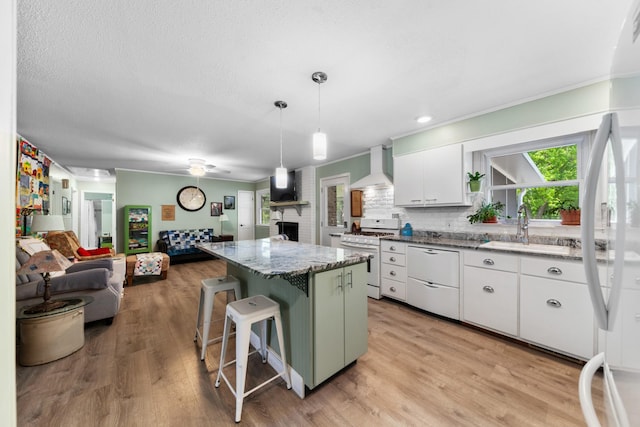 1205 Parker Dr, Pulaski, TN 38478 - kitchen featuring white appliances, a sink, wall chimney exhaust hood, open floor plan, and white cabinets