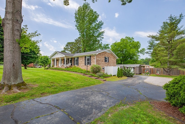 1205 Parker Dr, Pulaski, TN 38478 - view of front facade featuring a porch, brick siding, and asphalt driveway