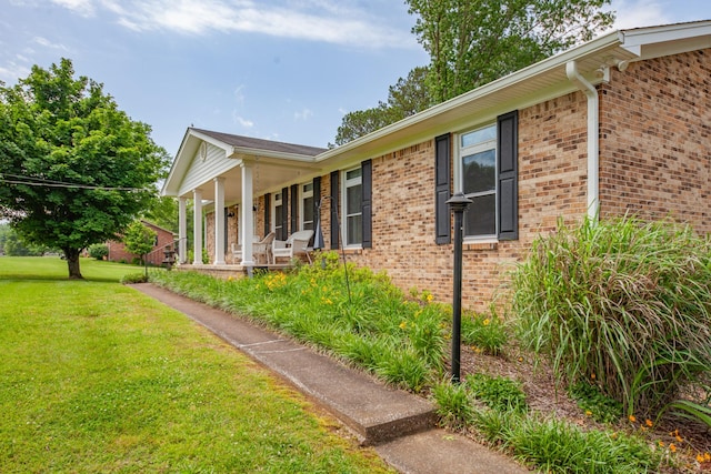 1205 Parker Dr, Pulaski, TN 38478 - view of property exterior featuring a yard, covered porch, and brick siding