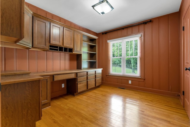 220 Porters Bluff Rd, Clarksville, TN 37040 - unfurnished office with built in study area, a decorative wall, and light wood-style flooring