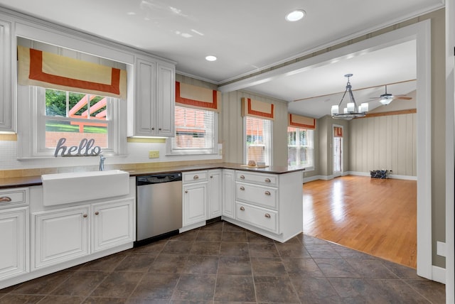 220 Porters Bluff Rd, Clarksville, TN 37040 - kitchen with stainless steel dishwasher, a peninsula, a sink, tasteful backsplash, and dark countertops