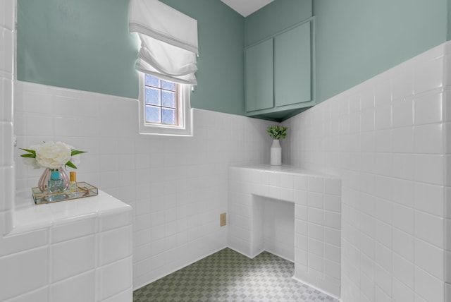 220 Porters Bluff Rd, Clarksville, TN 37040 - bathroom with tile walls, a wainscoted wall, and tile patterned floors