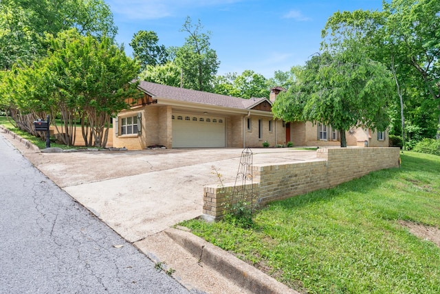 220 Porters Bluff Rd, Clarksville, TN 37040 - single story home with an attached garage, concrete driveway, a chimney, brick siding, and a front lawn