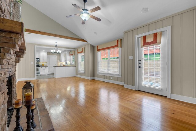 220 Porters Bluff Rd, Clarksville, TN 37040 - unfurnished living room with light wood-style flooring, lofted ceiling, a ceiling fan, a chandelier, and a decorative wall