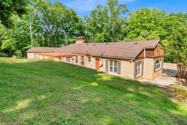 220 Porters Bluff Rd, Clarksville, TN 37040 - rear view of property featuring brick siding, a yard, a chimney, and a shingled roof