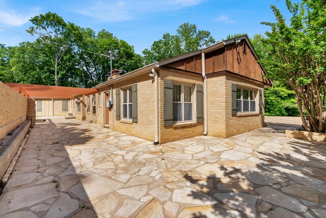 220 Porters Bluff Rd, Clarksville, TN 37040 - back of house with brick siding, a patio area, and a chimney