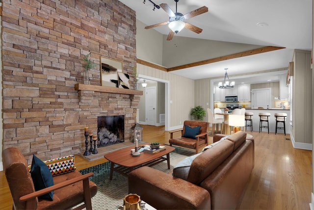 220 Porters Bluff Rd, Clarksville, TN 37040 - living area with a ceiling fan, light wood finished floors, a fireplace, and high vaulted ceiling
