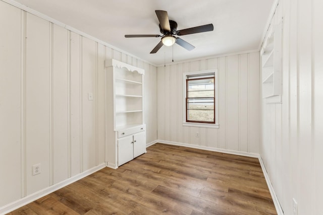 25 Lock Seven Ln, Carthage, TN 37030 - empty room featuring wood finished floors, ceiling fan, baseboards, crown molding, and a decorative wall