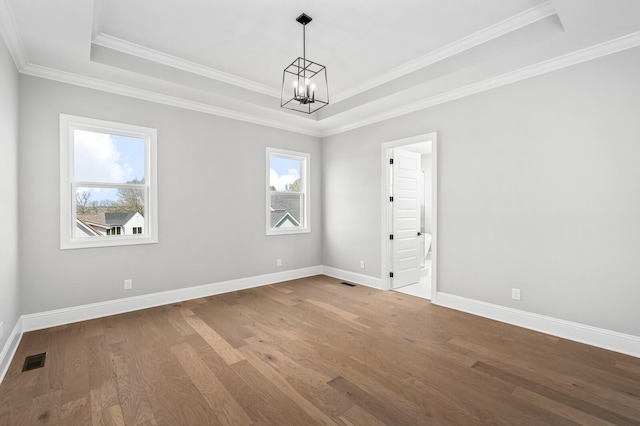 129 Barlow Dr, Franklin, TN 37064 - spare room with a raised ceiling, a chandelier, wood finished floors, baseboards, and crown molding