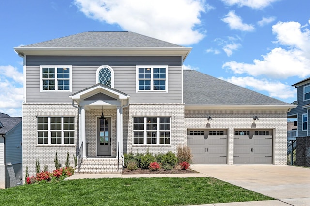 129 Barlow Dr, Franklin, TN 37064 - view of front of property featuring brick siding, a garage, concrete driveway, and a front yard