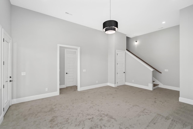 129 Barlow Dr, Franklin, TN 37064 - unfurnished living room featuring light colored carpet, stairway, baseboards, and recessed lighting