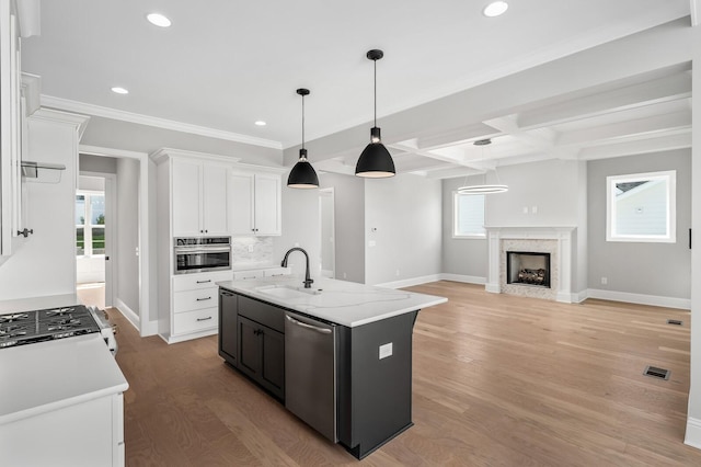 129 Barlow Dr, Franklin, TN 37064 - kitchen featuring a sink, appliances with stainless steel finishes, white cabinetry, baseboards, and beamed ceiling
