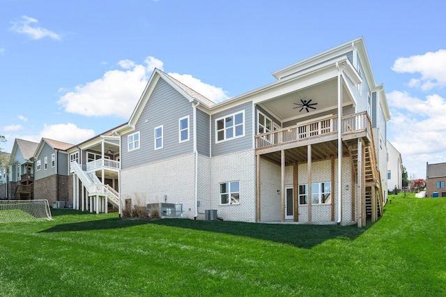 129 Barlow Dr, Franklin, TN 37064 - back of house with stairway, ceiling fan, a lawn, and brick siding