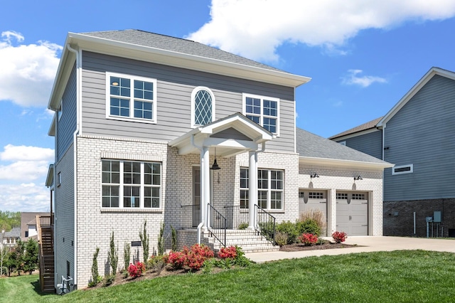 129 Barlow Dr, Franklin, TN 37064 - view of front of house with brick siding, driveway, an attached garage, and a front lawn