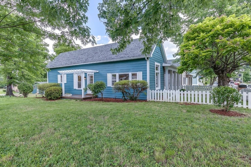view of front of house featuring roof with shingles and a pergola