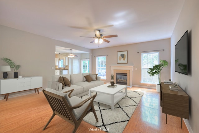 4002 Lattigo Ct, Spring Hill, TN 37174 - living room featuring plenty of natural light, light wood-style floors, a ceiling fan, and a glass covered fireplace
