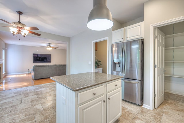 4002 Lattigo Ct, Spring Hill, TN 37174 - kitchen featuring stainless steel fridge with ice dispenser, a ceiling fan, a kitchen island, white cabinetry, and dark stone countertops
