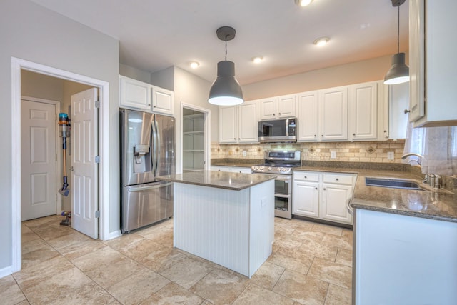 4002 Lattigo Ct, Spring Hill, TN 37174 - kitchen with appliances with stainless steel finishes, a sink, decorative backsplash, and white cabinets