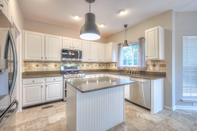4002 Lattigo Ct, Spring Hill, TN 37174 - kitchen with stainless steel appliances, a sink, white cabinets, and tasteful backsplash