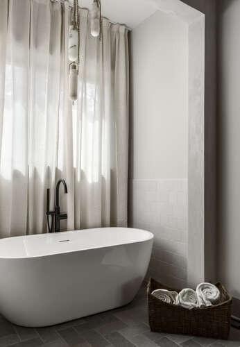 full bath featuring a freestanding bath and a sink