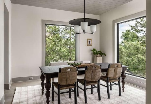 dining area featuring healthy amount of natural light, baseboards, and light wood finished floors