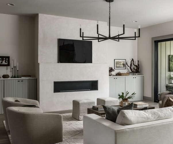 living room featuring a glass covered fireplace, a chandelier, and recessed lighting