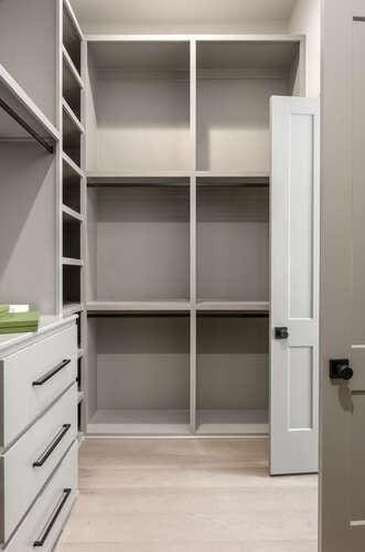 walk in closet with light wood finished floors