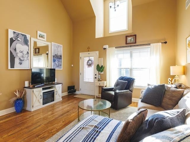 302 Janie St, Smyrna, TN 37167 - living room with baseboards, high vaulted ceiling, wood finished floors, and a fireplace