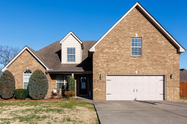 302 Janie St, Smyrna, TN 37167 - view of front of home with brick siding, concrete driveway, a garage, and roof with shingles