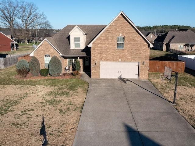 302 Janie St, Smyrna, TN 37167 - traditional-style home with an attached garage, brick siding, and concrete driveway