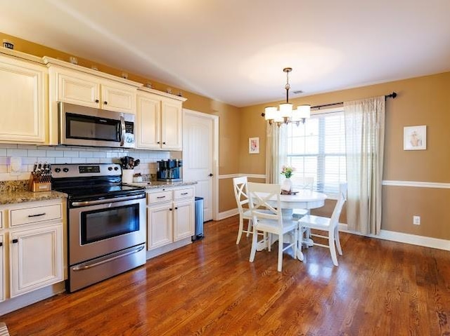 302 Janie St, Smyrna, TN 37167 - kitchen featuring appliances with stainless steel finishes, a chandelier, tasteful backsplash, and baseboards