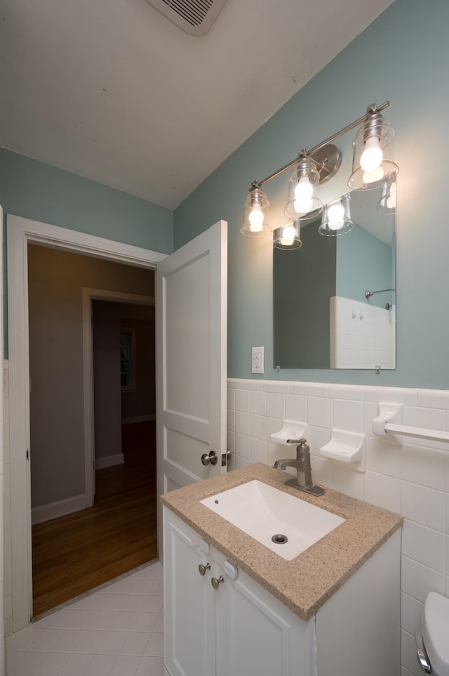 3310 Glencliff Rd, Nashville, TN 37211 - bathroom featuring tile walls, toilet, tile patterned floors, vanity, and a wainscoted wall