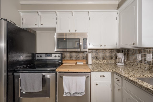 3310 Glencliff Rd, Nashville, TN 37211 - kitchen with appliances with stainless steel finishes, white cabinets, backsplash, and crown molding