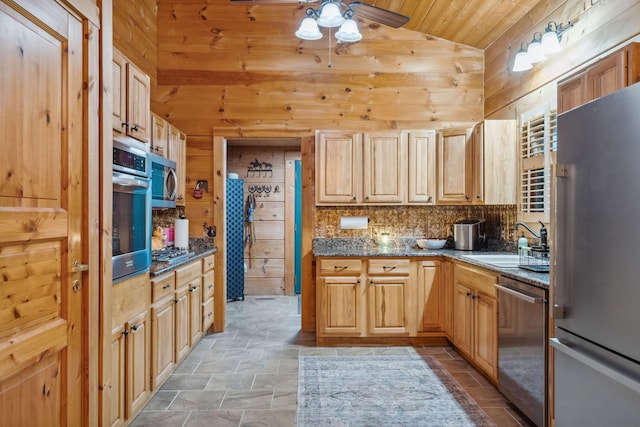 10120 Lascassas Pike, Lascassas, TN 37085 - kitchen featuring appliances with stainless steel finishes, wood walls, lofted ceiling, ceiling fan, and light stone finish floors