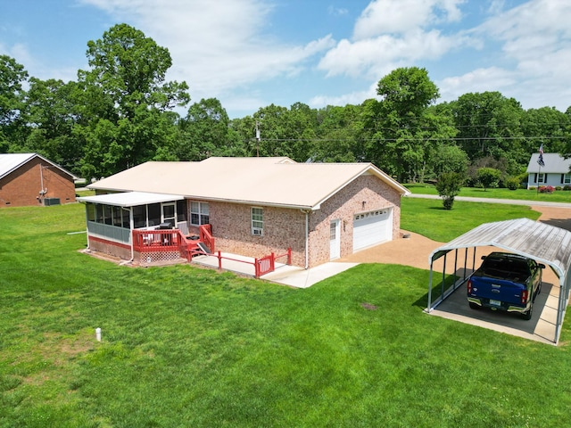 111 Hickory Trce, Lyles, TN 37098 - rear view of house featuring a sunroom, brick siding, a yard, driveway, and a wooden deck