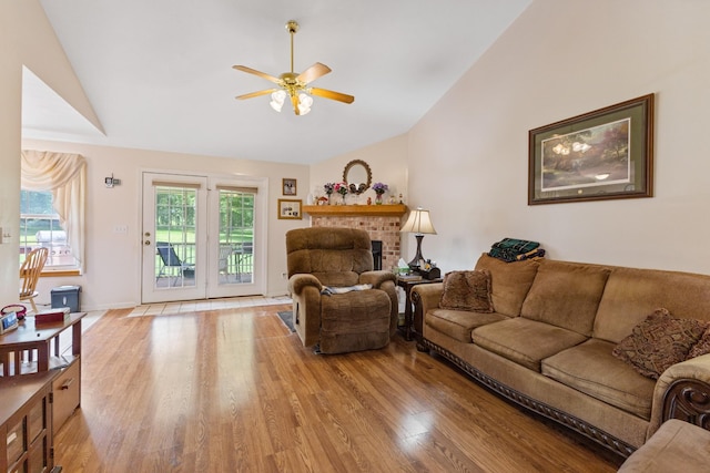 111 Hickory Trce, Lyles, TN 37098 - living area with vaulted ceiling, ceiling fan, light wood-style floors, a brick fireplace, and baseboards