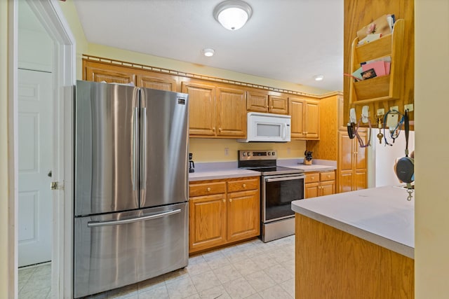 111 Hickory Trce, Lyles, TN 37098 - kitchen with stainless steel appliances, light countertops, and brown cabinetry