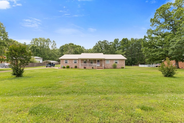 111 Hickory Trce, Lyles, TN 37098 - view of front facade with a carport, a porch, brick siding, and view of scattered trees